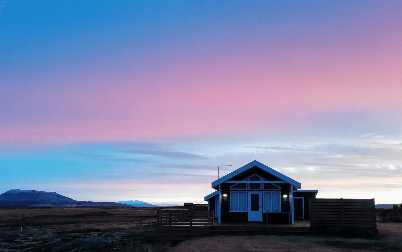 Cabin at dusk with pink sky